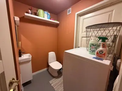 a small bathroom with a toilet and a sink at Rustic Retreat Apartment, Central & free parking ! in Trondheim
