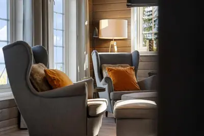 a waiting room with chairs and a table and windows at Mosetra2038 by Vacationtrysil in Trysil