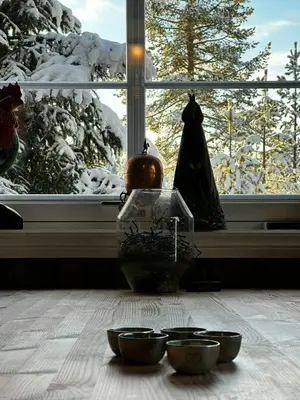 a group of bowls on a table in front of a window at Cabin By Trillemarka Nature Reserve in Eiddal