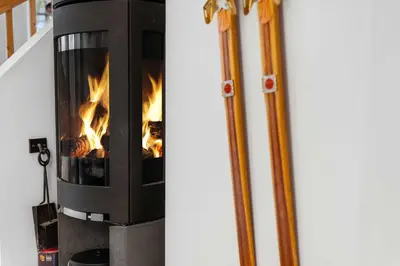 a fireplace with a fire inside of it at Fjellvangvegen 11 by Vacation Trysil in Trysil