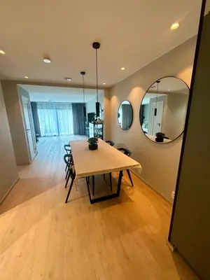 a dining room with a table and a mirror at Spacious, central 3 BR house with parking in Bergen