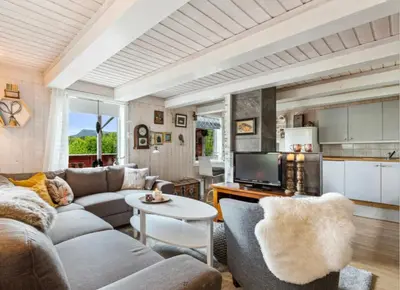 a living room with a couch and a table at Kvila in Tingvoll