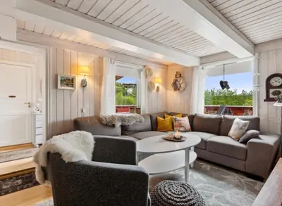 a living room with a couch and a table at Kvila in Tingvoll