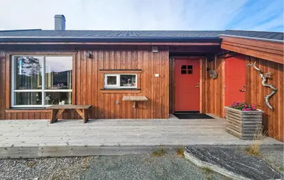 a wooden cabin with a red door and a bench at 3 Bedroom Lovely Home In Flå in Flå