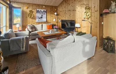 a living room with two couches and a tv at 3 Bedroom Lovely Home In Flå in Flå