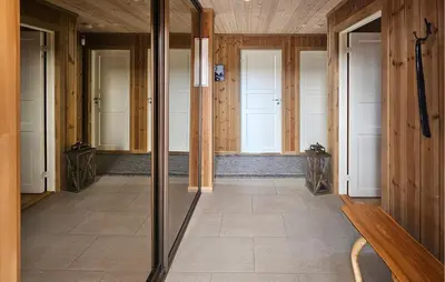 a hallway with glass doors and a wooden wall at 3 Bedroom Lovely Home In Flå in Flå