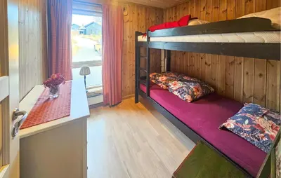 a room with two bunk beds in a cabin at 3 Bedroom Lovely Home In Flå in Flå