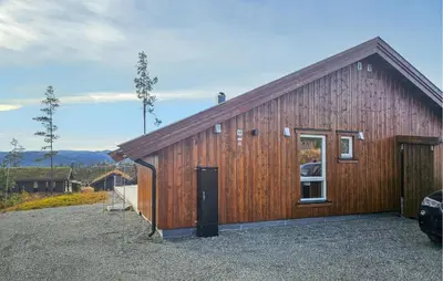 a wooden barn with a door and a window at 3 Bedroom Lovely Home In Flå in Flå