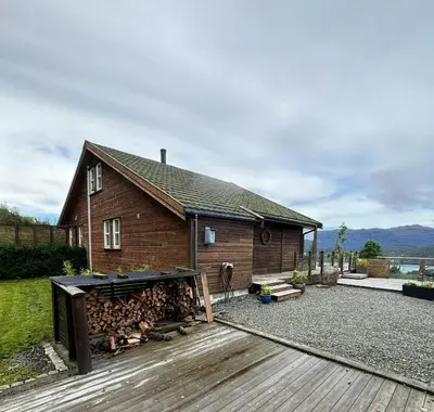 a house with a pile of fire wood in front of it at Modern Cabin With Panoramic Views In Aukland in Jelsa