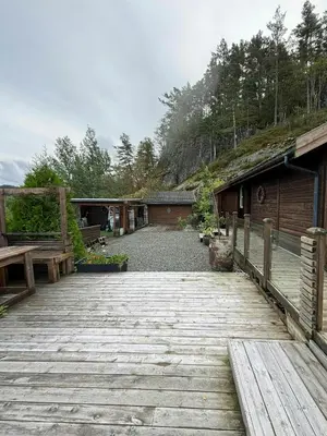 a wooden walkway with benches and a building at Modern Cabin With Panoramic Views In Aukland in Jelsa