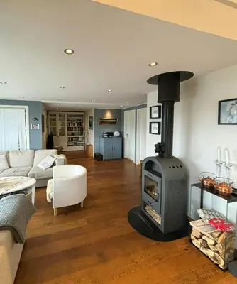 a living room with a wood stove in it at Modern Cabin With Panoramic Views In Aukland in Jelsa