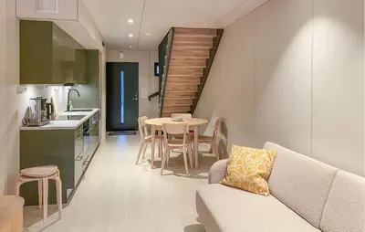 a kitchen and a living room with a couch and a table at Beautiful Home In Bjorli in Bjorli