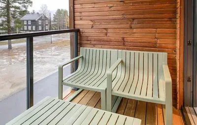 a bench sitting on the deck of a house at Beautiful Home In Bjorli in Bjorli