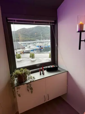 a window in a room with a view of a marina at Askvik Marina Lägenhet i småbåtshamn med havsutsikt