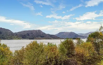 a large body of water with mountains in the background at Beach Front Home In Vaksdal With House Sea View in Vaksdal