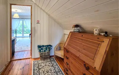 a small room with a dresser in a room at Beach Front Home In Vaksdal With House Sea View in Vaksdal