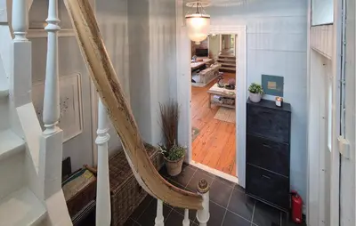 a stairway with a wooden floor and a stair case at Beach Front Home In Vaksdal With House Sea View in Vaksdal