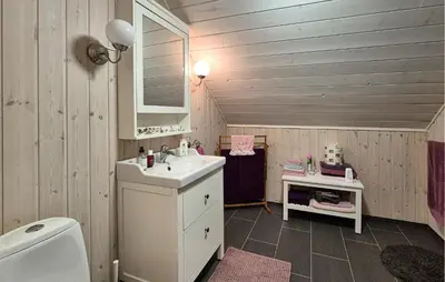 a bathroom with a sink and a toilet at Beach Front Home In Vaksdal With House Sea View in Vaksdal