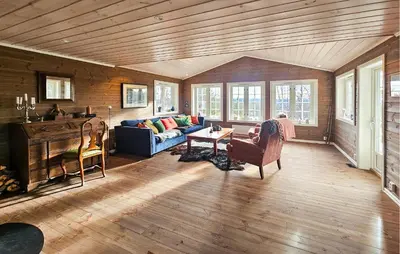 a living room with a couch and a table at Stunning Home In Torpo With Wifi in Torpo