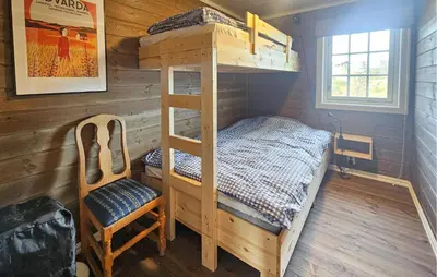a bedroom with a bunk bed and a chair at Stunning Home In Torpo With Wifi in Torpo