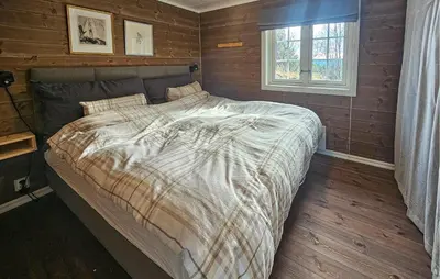 a large bed in a bedroom with a window at Stunning Home In Torpo With Wifi in Torpo