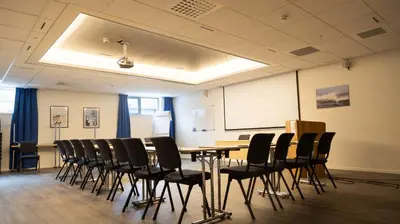 a conference room with a table and chairs at Vestnes Fjordhotell in Vestnes