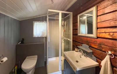 a bathroom with a toilet and a sink and a mirror at 3 Bedroom Cozy Home In Mesnali in Mesnali