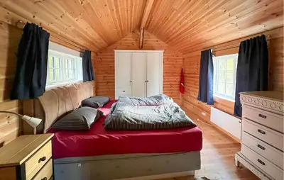 a bed in a small room in a tiny house at 3 Bedroom Cozy Home In Mesnali in Mesnali