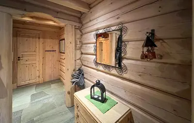 a log cabin room with a mirror and a wooden wall at Lovely Home In Sjusjøen With Sauna in Sjusjøen