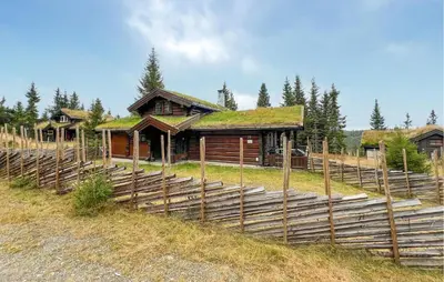 a log cabin with a grass roof on a hill at Lovely Home In Sjusjøen With Sauna in Sjusjøen