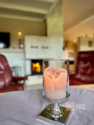 a candle in a glass on a table at Spacious cabin in Hemsedal with sauna, near slopes in Hemsedal