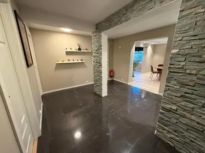 a hallway of a home with a stone wall at Kristiansund Luxury Apartment in Kristiansund