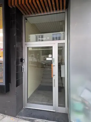 an entrance to a building with a glass door at Kristiansund Luxury Apartment in Kristiansund