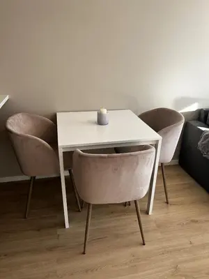 a white table with chairs and a candle on it at Newly refurbished apartment in the city center in Verdal