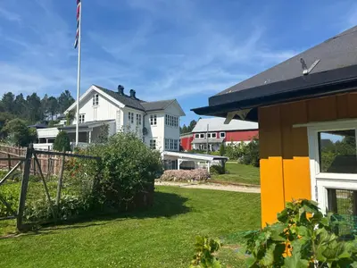 a house with an american flag in a yard at Strand huset in Hitra