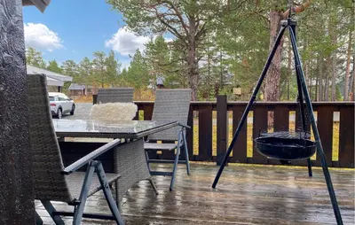 a patio with a table and a grill on a deck at Gorgeous Home In Bjorli With Wifi in Bjorli