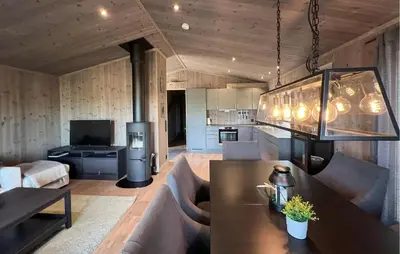 a living room with a table and a kitchen at Stunning Home In Gålå With Wifi in Gålå