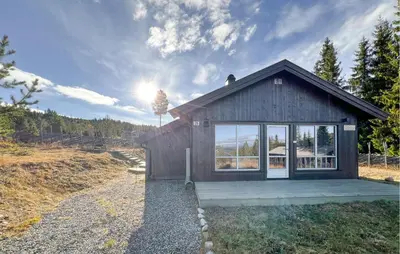 a small house with a large window on a hill at Stunning Home In Gålå With Wifi in Gålå