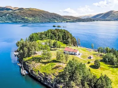 an aerial view of a house on an island in a lake at Holiday Home Holmen by Interhome in Strandebarm