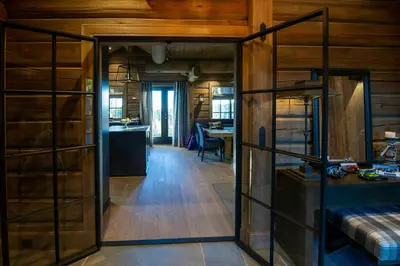 an open room with a kitchen and a living room at Handcrafted Log Cabin At Golsfjellet in Gol