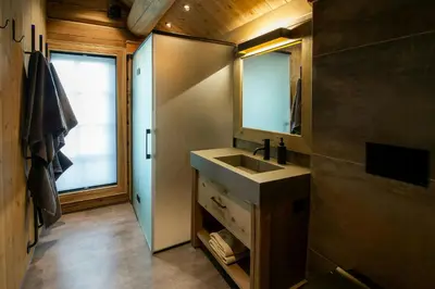 a bathroom with a sink and a mirror at Handcrafted Log Cabin At Golsfjellet in Gol