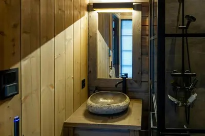 a bathroom with a bowl sink on a counter at Handcrafted Log Cabin At Golsfjellet in Gol