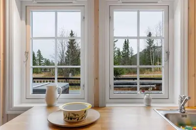 a kitchen with two windows and a coffee cup on a counter at Fagerasen 303 by Vacation Trysil in Trysil