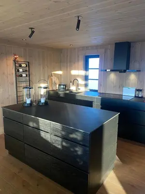 a kitchen with a black counter top in a room at Exclusive cottage on Geilo in Hol