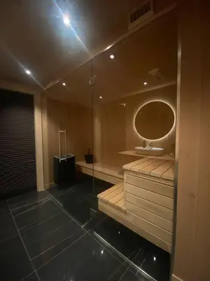 a bathroom with a shower with a sink and a mirror at Exclusive cottage on Geilo in Hol