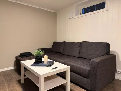 a living room with a couch and a table at Ny leilighet i Stjørdal in Stjoerdal