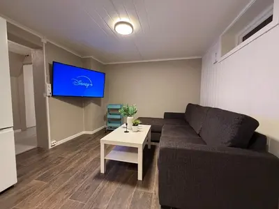 a living room with a couch and a table at Ny leilighet i Stjørdal in Stjoerdal