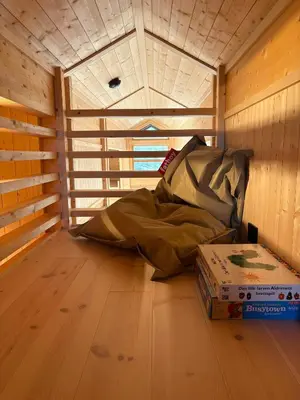 a room with a bed and two boxes on the floor at Ål Cabin With Views Of Marshland And Mountains in Flå