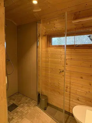 a bathroom with a shower with a toilet and a sink at Ål Cabin With Views Of Marshland And Mountains in Flå