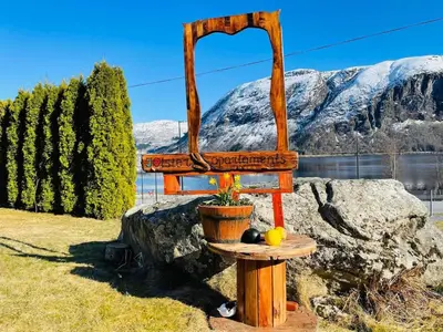 a bird feeder on a table with fruit on it at JOlster apartaments - lake view in Årdal